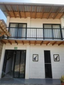 a house with a balcony with a deck at Casa Berenice in Zorritos +18 photos