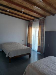 a bedroom with two beds and a large window at Casa Berenice in Zorritos