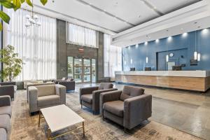a waiting room with chairs and a reception desk at Sandman Hotel & Suites Calgary West in Calgary