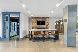 a conference room with a table and chairs and a tv at Sandman Hotel & Suites Calgary West in Calgary