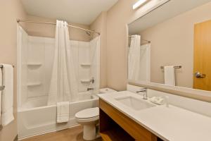 a bathroom with a sink and a toilet and a shower at LivAway Suite Tucson in Tucson +6 photos