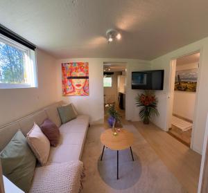 a living room with a couch and a table at Mysig Lägenhet in Varberg