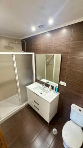 a bathroom with a sink and a toilet and a shower at Aqui é o seu lugar. in Bobadela