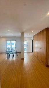an empty room with a table and chairs in a building at Aqui é o seu lugar. in Bobadela