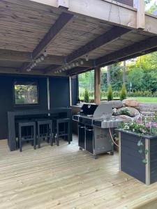 an outdoor patio with a grill and a table at Mysig Lägenhet in Varberg