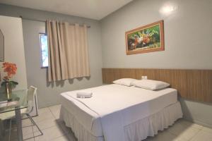 a bedroom with a bed and a table and a window at Hotel Aeroporto Star in Fortaleza +32 photos