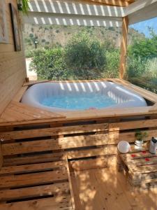 a jacuzzi tub in a patio with a window at il tramonto in Capaci