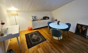a living room with a table and chairs in a room at Mansarda Acquamarina in Viareggio