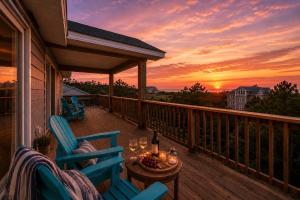 a balcony with two chairs and a table with wine glasses at OPM Coastal Retreat in Salvo