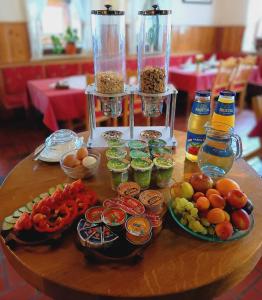 a table with food and drinks on top of it at PAVLIN Bed & Breakfast in Šenturska Gora