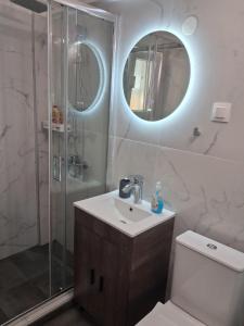 a bathroom with a sink and a shower with a mirror at S&A New Chile AXD in Alexandroupoli +25 photos