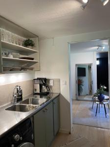 a kitchen with a sink and a counter top at Mysig Lägenhet in Varberg
