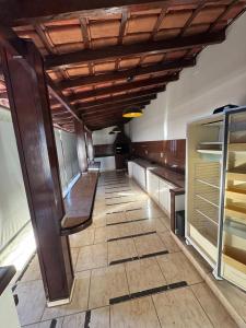 a large kitchen with a wooden ceiling and a tile floor at Casa Villa Coloniale in Espirito Santo Do Pinhal