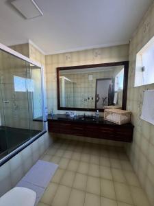 a bathroom with a large mirror and a sink at Casa Villa Coloniale in Espirito Santo Do Pinhal +29 photos