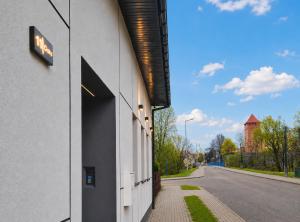 a building with a sign on the side of a street at Apartment Quiet Street 11, 3E in Oświęcim +5 photos
