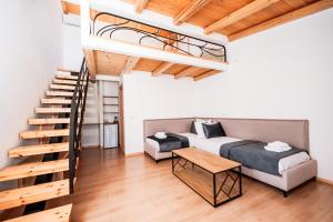 a living room with a bed and a staircase at Vila Milo in Himare +248 photos