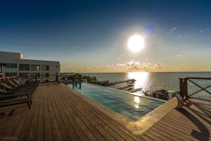 a swimming pool on the deck of a building at Sandbar Beachfront Hotel & Hostel Restaurant in San Pedro