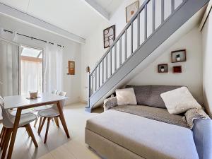 a living room with a couch and a table at Maison village accès mer et commerces à pieds in Le Barcarès