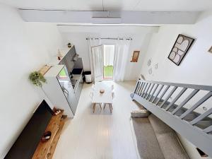 an attic hallway with stairs and a stair case at Maison village accès mer et commerces à pieds in Le Barcarès +8 photos