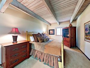 a bedroom with a bed and a dresser with a lamp at Timberline Condominiums 3 Bedroom Standard Unit D2A in Snowmass Village