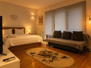 a hotel room with a bed and a couch at Monte Carlo Palace Suites in Bucharest +71 photos