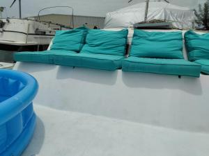 a blue couch on the back of a boat at party like a local in Key West