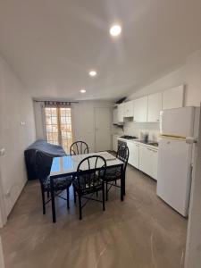 a kitchen with a table and chairs and a refrigerator at Chiara 5 in Cairo Montenotte +2 photos