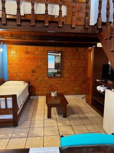 a bedroom with a bed and a table in a room at hotel le Massilia in Belém