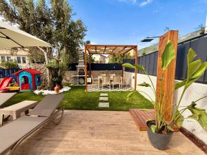 a backyard with a garden with a table and chairs at As Villas Villa Asil in Fethiye
