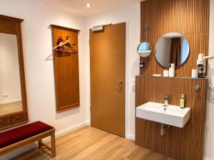 a bathroom with a sink and a mirror at Hotel Night4Flight Hamburg-Airport in Hamburg