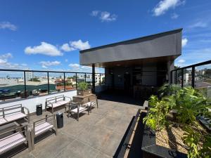 a balcony with benches and a view of a city at Haven Residence in Uberlândia