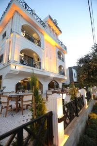 a building with tables and chairs in front of it at Italy hotel in Silifke
