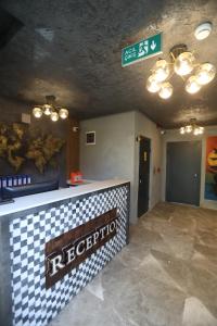 a restaurant with a checkered counter and a sign at Italy hotel in Silifke