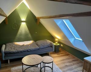 a living room with a couch and two tables at Ferienhaus Schwalmblick in Schwalmstadt