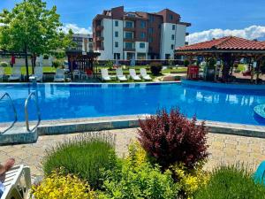 a large blue swimming pool with a gazebo at By The Pool Apartments #10 in Velingrad