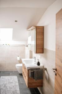 a bathroom with a sink and a toilet at Ferienwohnungen Kreuzer in Regen +20 photos