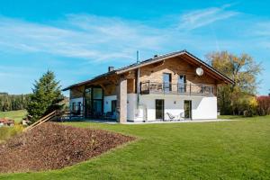 a house on a hill with a large yard at Ferienwohnungen Kreuzer in Regen