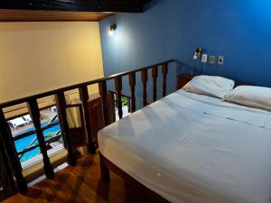 a bed in a room with a balcony at hotel le Massilia in Belém +50 photos