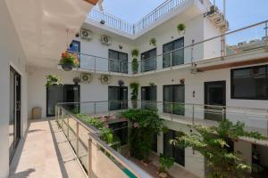 an apartment building with plants on the balconies at Hotel Fusión in Puerto Escondido