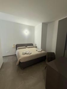 a bedroom with a bed with two towels on it at Chiara 2 in Cairo Montenotte