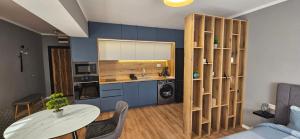 a living room with a table and a kitchen at By The Pool Apartments #10 in Velingrad