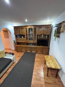 a living room with a large wooden cabinet at Rustic Paradise Turda in Turda