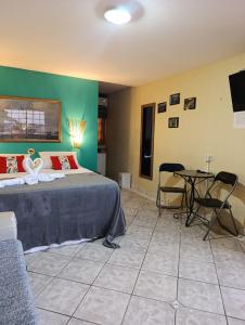 a bedroom with a bed and a table and chairs at Hotel Pousada Viking in Jacumã +113 photos
