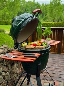 a grill with a plate of food on a patio at Kelgumäe in Otepää