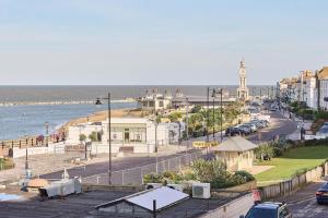 a view of a city with a street and the ocean at Coastal charm in Herne Bay