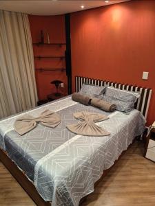 a bedroom with a bed with two towels on it at Flat no Hotel Millenium Manaus in Manaus +40 photos