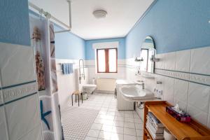 a blue and white bathroom with a sink and a toilet at Int Dörpe in Lengerich +7 photos
