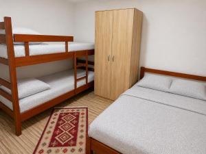 a small room with two bunk beds and a cabinet at Blue Eye in Vusanje