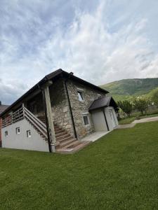 a stone building with stairs on the side of it at Blue Eye in Vusanje