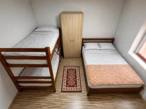 a small room with two bunk beds and a cabinet at Blue Eye in Vusanje